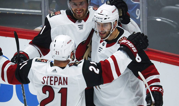 Arizona Coyotes right wing Tobias Rieder, center, of Germany, is congratulated after his goal by ce...