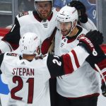 Arizona Coyotes right wing Tobias Rieder, center, of Germany, is congratulated after his goal by center Derek Stepan, front, and left wing Brendan Perlini in the first period of an NHL hockey game against the Colorado Avalanche, Wednesday, Dec. 27, 2017, in Denver. (AP Photo/David Zalubowski)