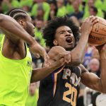 Phoenix Suns forward Josh Jackson (20) drives against Minnesota Timberwolves forward Andrew Wiggins (22) in the first quarter of an NBA basketball game on Saturday, Dec. 16, 2017, in Minneapolis. (AP Photo/Andy Clayton-King)