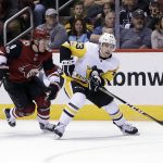 Pittsburgh Penguins left wing Conor Sheary (43) carries the puck from Arizona Coyotes center Clayton Keller in the third period during an NHL hockey game, Saturday, Dec 16, 2017, in Glendale, Ariz. Pittsburgh defeated Arizona 4-2. (AP Photo/Rick Scuteri)