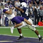 Washington wide receiver Aaron Fuller (12) pulls in a touchdown pass as Penn State linebacker Jason Cabinda (40) defends during the second half of the Fiesta Bowl NCAA college football game, Saturday, Dec. 30, 2017, in Glendale, Ariz. (AP Photo/Rick Scuteri)