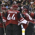 Arizona Coyotes' Jordan Martinook, right, is congratulated by Joel Hanley (39), Kevin Connauton (44) and others after scoring a goal against the New Jersey Devils during the second period of an NHL hockey game, Saturday, Dec. 2, 2017, in Glendale, Ariz. (AP Photo/Ralph Freso)