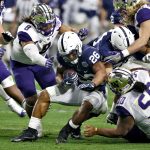 Penn State running back Saquon Barkley (26) is hit by Washington linebacker Benning Potoa'e (8) during the first half of the Fiesta Bowl NCAA college football game, Saturday, Dec. 30, 2017, in Glendale, Ariz. (AP Photo/Ross D. Franklin)