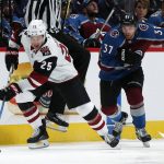Arizona Coyotes center Nick Cousins, left, races downice with the puck past Colorado Avalanche left wing J.T. Compher in the second period of an NHL hockey game Wednesday, Dec. 27, 2017, in Denver. (AP Photo/David Zalubowski)