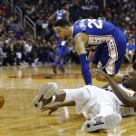 Phoenix Suns forward Josh Jackson, right, passes the ball after battling with Philadelphia 76ers guard Ben Simmons (25) for possession during the first half of an NBA basketball game Sunday, Dec. 31, 2017, in Phoenix. (AP Photo/Ross D. Franklin)