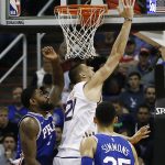 Phoenix Suns center Alex Len (21) is fouled by Philadelphia 76ers forward Amir Johnson, left, as 76ers guard Ben Simmons (25) looks on during the first half of an NBA basketball game, Sunday, Dec. 31, 2017, in Phoenix. (AP Photo/Ross D. Franklin)
