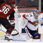 Florida Panthers goalie James Reimer (34) makes a save on a shot by Arizona Coyotes right wing Christian Fischer (36) during the first period of an NHL hockey game, Tuesday, Dec. 19, 2017, in Glendale, Ariz. (AP Photo/Ross D. Franklin)