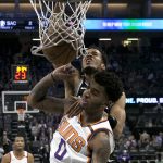 Sacramento Kings forward Skal Labissiere, background, stuffs over Phoenix Suns forward Marquese Chriss during the first quarter of an NBA basketball game Tuesday, Dec. 12, 2017, in Sacramento, Calif. (AP Photo/Rich Pedroncelli)