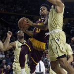 Arizona State guard Tra Holder (0) drives on Vanderbilt forward Jeff Roberson in the second half during an NCAA college basketball game, Sunday, Dec 17, 2017, in Tempe, Ariz. Arizona State defeated Vanderbilt 76-64. (AP Photo/Rick Scuteri)