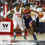 Arizona's Allonzo Trier tries to dribble past New Mexico's Sam Logwood in the first half of an NCAA college basketball game, Saturday, Dec. 16, 2017, in Albuquerque, N.M. (AP Photo/Eric Draper)