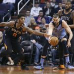 Phoenix Suns' Marquese Chriss (0) reaches in to steal the ball from Memphis Grizzlies' Marc Gasol, center, as Suns' Greg Monroe defends during the first half of an NBA basketball game Thursday, Dec. 21, 2017, in Phoenix. The Suns defeated the Grizzlies 97-95. (AP Photo/Ralph Freso)