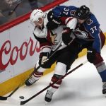 Arizona Coyotes defenseman Luke Schenn, left, vies for control of the puck with Colorado Avalanche left wing J.T. Compher during the third period of an NHL hockey game Wednesday, Dec. 27, 2017, in Denver. The Coyotes won 3-1. (AP Photo/David Zalubowski)