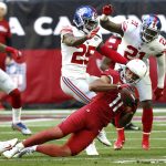 Arizona Cardinals wide receiver Larry Fitzgerald (11) makes a catch as New York Giants defensive back Brandon Dixon (25) defends during the first half of an NFL football game, Sunday, Dec. 24, 2017, in Glendale, Ariz. (AP Photo/Ross D. Franklin)