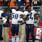 Tennessee Titans linebacker Nate Palmer (50) raises a fist during the playing of the national anthem as teammate Avery Williamson (54) stands next to Palmer prior to an NFL football game against the Arizona Cardinals, Sunday, Dec.10, 2017, in Glendale, Ariz. (AP Photo/Ralph Freso)