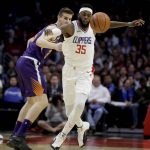 Los Angeles Clippers center Willie Reed, right, steals the ball away from Phoenix Suns forward Dragan Bender during the second half of an NBA basketball game in Los Angeles, Wednesday, Dec. 20, 2017. The Clippers won 108-95. (AP Photo/Chris Carlson)