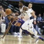 Phoenix Suns guard Troy Daniels (30) and Dallas Mavericks guard Wesley Matthews (23) chase the ball during the second half of an NBA basketball game in Dallas, Monday, Dec. 18, 2017. (AP Photo/LM Otero)