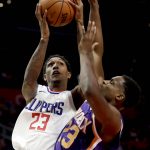Los Angeles Clippers guard Lou Williams, left, shoots over Phoenix Suns forward Danuel House Jr. during the second half of an NBA basketball game in Los Angeles, Wednesday, Dec. 20, 2017. The Clippers won 108-95. (AP Photo/Chris Carlson)