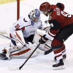 Arizona Coyotes center Clayton Keller (9) controls the puck before beating Washington Capitals goalie Philipp Grubauer (31) for the game-winning goal during overtime in an NHL hockey game, Friday, Dec. 22, 2017, in Glendale, Ariz. The Coyotes won 3-2. (AP Photo/Ross D. Franklin)