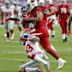 Arizona Cardinals wide receiver Larry Fitzgerald (11) makes the catch as New York Giants defensive back Darryl Morris (23) makes the hit during the first half of an NFL football game, Sunday, Dec. 24, 2017, in Glendale, Ariz. (AP Photo/Rick Scuteri)