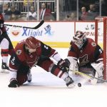 Arizona Coyotes goalie Scott Wedgewood (31) makes a save on a shot as defenseman Luke Schenn (2) tries to clear the puck from the front of the net while New Jersey Devils' Jimmy Hayes (10) skates in during the third period of an NHL hockey game, Saturday, Dec. 2, 2017, in Glendale, Ariz. The Coyotes defeated the Devils 5-0. (AP Photo/Ralph Freso)