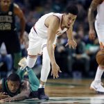 Boston Celtics' Marcus Smart, lower left, falls on the court while battling Phoenix Suns' Devin Booker, center, for a loose ball during the fourth quarter of an NBA basketball game in Boston, Saturday, Dec. 2, 2017. The Celtics won 116-111. (AP Photo/Michael Dwyer)