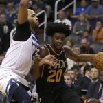 Phoenix Suns forward Josh Jackson (20) drives  against Minnesota Timberwolves forward Taj Gibson in the third quarter during an NBA basketball game, Saturday, Dec. 23, 2017, in Phoenix. (AP Photo/Rick Scuteri)
