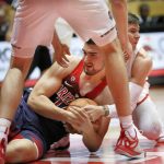 Arizona's Dusan Ristic hits the floor for a loose ball in front of New Mexico's Dane Kuiper in the second half of an NCAA college basketball game, Saturday, Dec. 16, 2017, in Albuquerque, N.M. (AP Photo/Eric Draper)