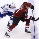 Arizona Coyotes center Derek Stepan (21) tries to keep the puck away from Tampa Bay Lightning center Yanni Gourde (37) during the second period of an NHL hockey game, Thursday, Dec. 14, 2017, in Glendale, Ariz. (AP Photo/Ross D. Franklin)