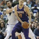 Phoenix Suns center Alex Len (21) is defended by Dallas Mavericks center Salah Mejri (50) during the first half of an NBA basketball game in Dallas, Monday, Dec. 18, 2017. (AP Photo/LM Otero)