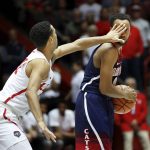 New Mexico's Anthony Mathis, left, defends against Arizona guard Parker Jackson-Cartwright in the second half of an NCAA college basketball game, Saturday, Dec. 16, 2017, in Albuquerque, N.M. (AP Photo/Eric Draper)