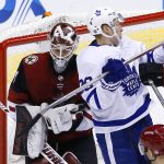 Arizona Coyotes goalie Scott Wedgewood, left, makes a save on a shot behind Toronto Maple Leafs right wing Connor Brown (28) during the third period of an NHL hockey game Thursday, Dec. 28, 2017, in Glendale, Ariz. The Maple Leafs defeated the Coyotes 7-4. (AP Photo/Ross D. Franklin)