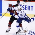 Tampa Bay Lightning defenseman Mikhail Sergachev (98) collides with Arizona Coyotes defenseman Kevin Connauton (44) during the first period of an NHL hockey game, Thursday, Dec. 14, 2017, in Glendale, Ariz. (AP Photo/Ross D. Franklin)