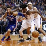 Phoenix Suns forward Josh Jackson, front right, battles with Philadelphia 76ers guard Ben Simmons (25) for a loose ball as Suns forward Jared Dudley, back right, watches during the first half of an NBA basketball game Sunday, Dec. 31, 2017, in Phoenix. (AP Photo/Ross D. Franklin)