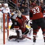 Arizona Coyotes goalie Scott Wedgewood (31) pauses with defenseman Alex Goligoski (33) after giving up a goal as Washington Capitals left wing Jakub Vrana (13), defenseman Matt Niskanen, second from left, and center Evgeny Kuznetsov (92) celebrate a goal by Capitals T.J. Oshie during the second period of an NHL hockey game, Friday, Dec. 22, 2017, in Glendale, Ariz. (AP Photo/Ross D. Franklin)