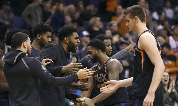 Phoenix Suns' Troy Daniels (30) and Dragan Bender, right, are congratulated by Alan Williams, cente...