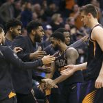 Phoenix Suns' Troy Daniels (30) and Dragan Bender, right, are congratulated by Alan Williams, center, and other teammates after Daniels made a 3-point basket to give the Suns the lead in the final minute against the Memphis Grizzlies in an NBA basketball game Thursday, Dec. 21, 2017, in Phoenix. (AP Photo/Ralph Freso)