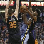Memphis Grizzlies guard Tyreke Evans (12) tries to drive to the basket between Phoenix Suns' Dragan Bender (35) and Josh Jackson during the second half of an NBA basketball game Thursday, Dec. 21, 2017, in Phoenix. The Suns defeated the Grizzlies 97-95. (AP Photo/Ralph Freso)