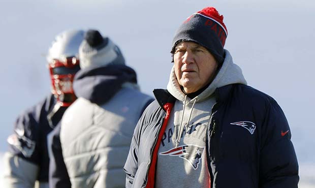 New England Patriots head coach Bill Belichick watches players stretching during an NFL football te...