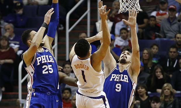 Phoenix Suns guard Devin Booker (1) has his shot altered by Philadelphia 76ers forward Dario Saric ...