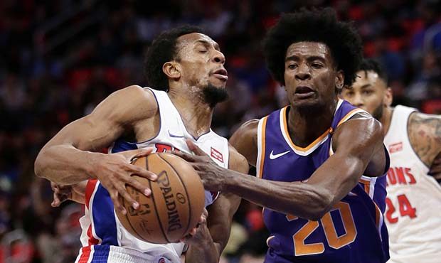 Detroit Pistons guard Ish Smith (14) is fouled by Phoenix Suns forward Josh Jackson (20) while driv...