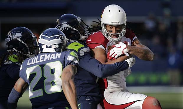 Arizona Cardinals wide receiver Larry Fitzgerald, right, is tackled by Seattle Seahawks cornerback ...