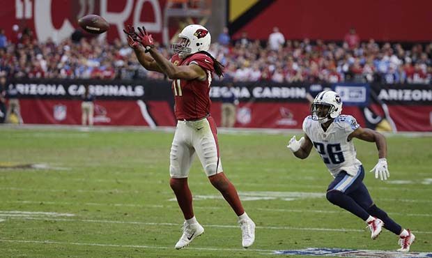 Arizona Cardinals wide receiver Larry Fitzgerald, left, makes a catch in front of Tennessee Titans ...