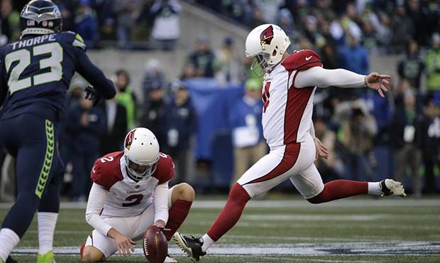 Arizona Cardinals kicker Phil Dawson, right, boots a field goal against the Seattle Seahawks in the...