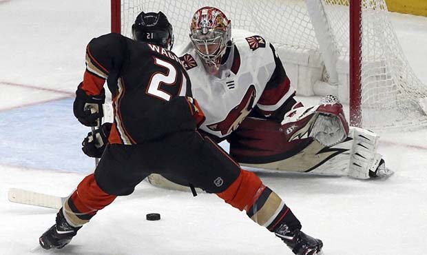 Arizona Coyotes goalie Antti Raanta (32) defends as Anaheim Ducks center Chris Wagner (21) attacks ...