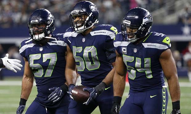 Seattle Seahawks' Michael Wilhoite (57), K.J. Wright (50) and Bobby Wagner (54) celebrate a pass by...
