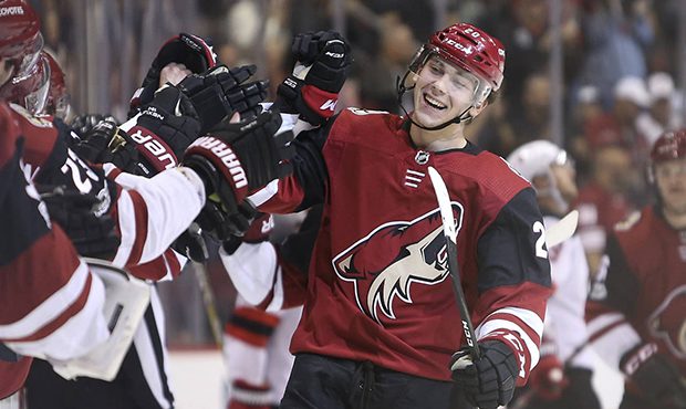 Arizona Coyotes' Dylan Strome, right, is congratulated by teammates after scoring a goal against th...