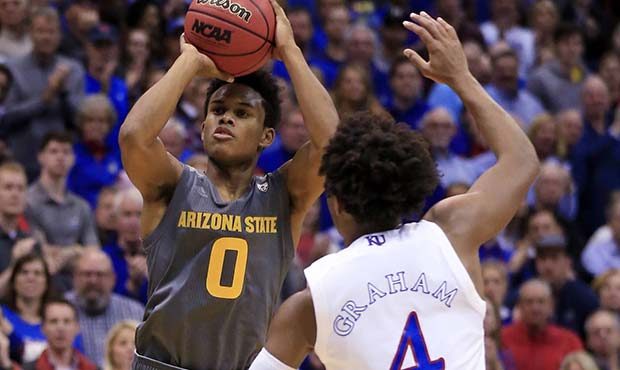 Arizona State guard Tra Holder (0) shoots over Kansas guard Devonte' Graham (4) during the second h...