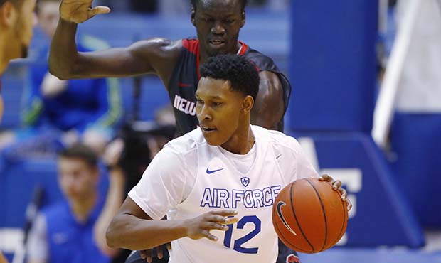 Air Force forward Lavelle Scottie, front, fields a pass while in the lane as New Mexico center Obij...