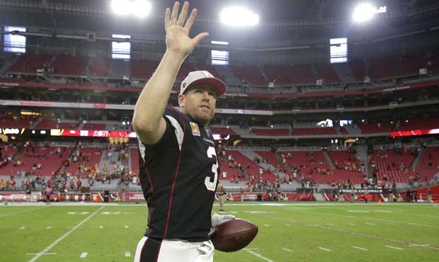 Arizona Cardinals quarterback Carson Palmer (3) waves to the fans as he jogs off the field after an...