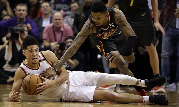 Phoenix Suns guard Devin Booker (1) and Atlanta Hawks guard Kent Bazemore battle for a loose ball i...